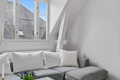 Bright and cozy living room with plenty of natural light, comfortable seating, and a large TV perfect for relaxing evenings. The sofa can also easily be converted into a comfortable sofa bed with space for 2 guests.