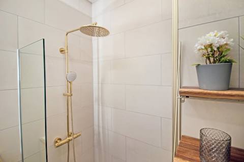 Contemporary full bathroom with a modern walk-in shower and elegant finishes. Designed with comfort and quality in mind, offering a refined, hotel-like experience
