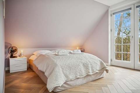 Cozy bedroom with double bed and French doors