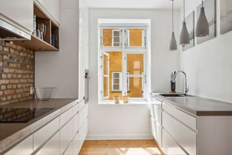 Open kitchen and living space with rare historic Copenhagen brick from the 1700s