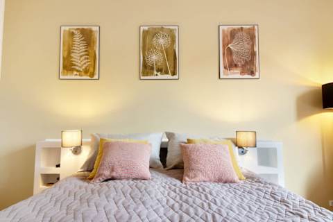 Spacious and serene bedroom featuring a luxurious king-size bed that can be separated into two single beds upon request, elegant décor, and generous storage. The perfect retreat to unwind after a day in the heart of Aarhus.
