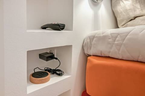 Elegant and spacious bedroom with a luxurious king-size bed, refined décor, generous storage, and a large flat-screen TV. A calm, high-end retreat designed for comfort and relaxation in central Aarhus.