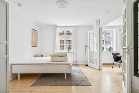 Spacious bedroom with a comfortable double bed — perfect for couples looking for a relaxing stay in the heart of the city.