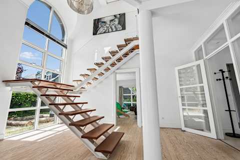 Step inside and experience a truly remarkable entrance, where soaring ceilings, beautiful natural light, and elegant Scandinavian design create an unforgettable first impression.