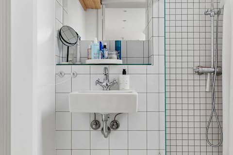 Clean and functional bathroom with shower, toilet, and fresh towels provided