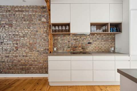 Open kitchen and living space with rare historic Copenhagen brick from the 1700s