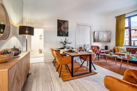 Beautiful, spacious living area with a sophisticated atmosphere and plenty of natural light. Enjoy a large flat-screen TV, comfortable seating, and a dining table perfect for relaxed dinners and social evenings.