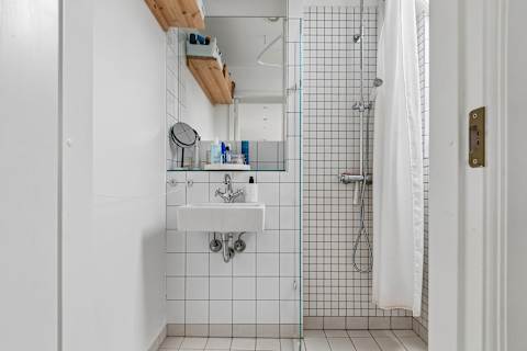 Clean and functional bathroom with shower, toilet, and fresh towels provided