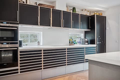 A cozy kitchen centered around the island and bar stools, designed for togetherness, good food and unhurried moments.