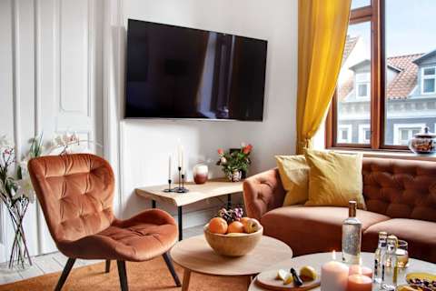 Beautiful, spacious living area with a sophisticated atmosphere and plenty of natural light. Enjoy a large flat-screen TV, comfortable seating, and a dining table perfect for relaxed dinners and social evenings.