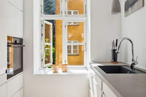 Open kitchen and living space with rare historic Copenhagen brick from the 1700s