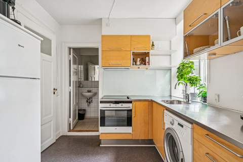 Start your morning with coffee in a clean, functional kitchen before stepping straight out into the vibrant city life.