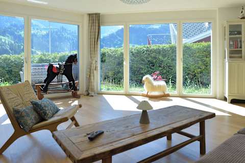 Relax in the bright and spacious living room, surrounded by floor-to-ceiling windows and beautiful mountain views in every direction.