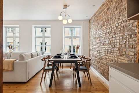 Open kitchen and living space with rare historic Copenhagen brick from the 1700s