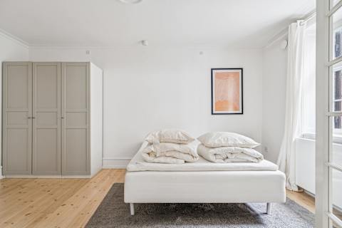 Spacious bedroom with a comfortable double bed — perfect for couples looking for a relaxing stay in the heart of the city.