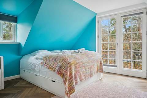 Cozy bedroom with double bed and French doors