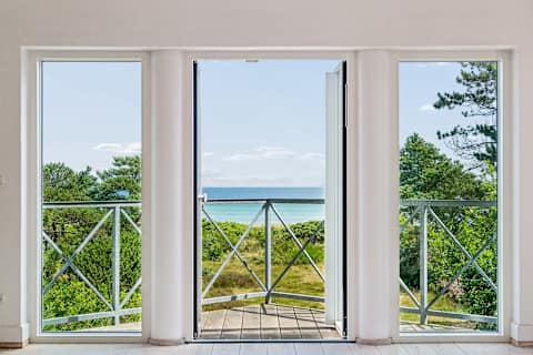 With panoramic sea views from the first floor, this inviting living room is a place you'll never want to leave. Light the fireplace on cooler evenings, enjoy a movie together, or simply relax as the sea quietly becomes part of the view.
