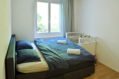 Spacious master bedroom featuring a comfortable double bed and private ensuite bathroom for added comfort and privacy.