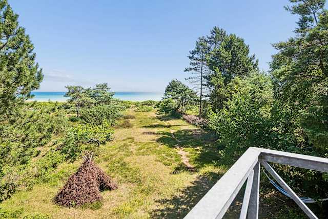 With panoramic sea views from the first floor, this inviting living room is a place you'll never want to leave. Light the fireplace on cooler evenings, enjoy a movie together, or simply relax as the sea quietly becomes part of the view.