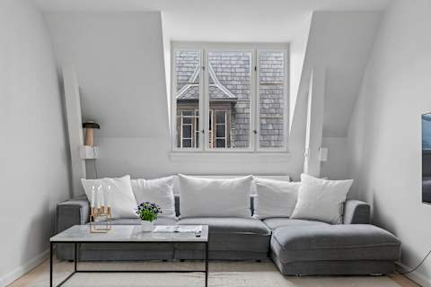 Bright and cozy living room with plenty of natural light, comfortable seating, and a large TV perfect for relaxing evenings. The sofa can also easily be converted into a comfortable sofa bed with space for 2 guests.