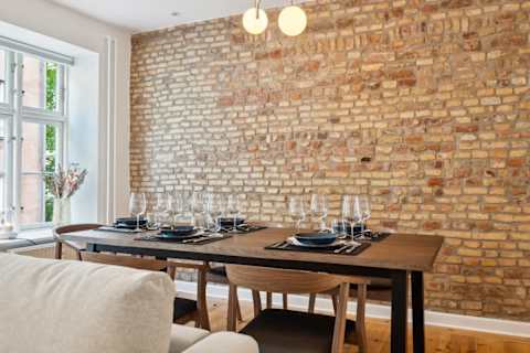 Open kitchen and living space with rare historic Copenhagen brick from the 1700s